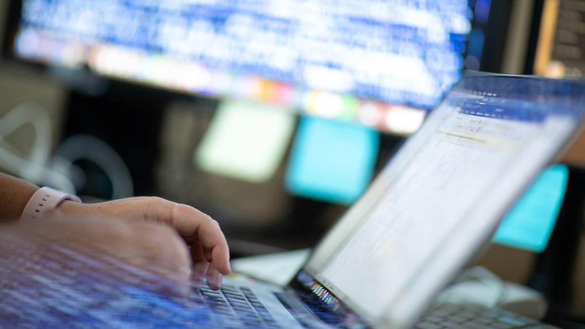 Close-up of hands typing on a laptop