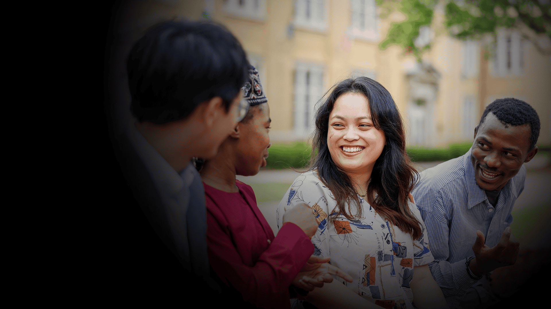 Group of international student talking and smiling outdoors