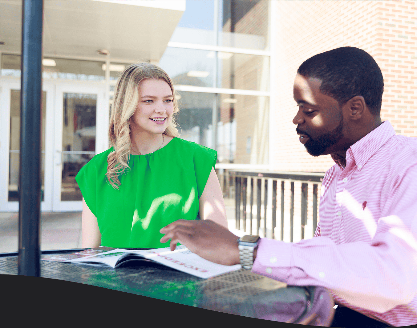 UA recruiter walking a student through a pamphlet