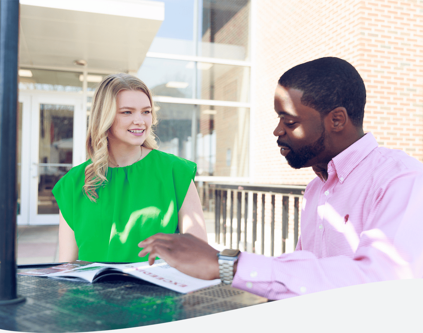 UA recruiter walking a student through a pamphlet