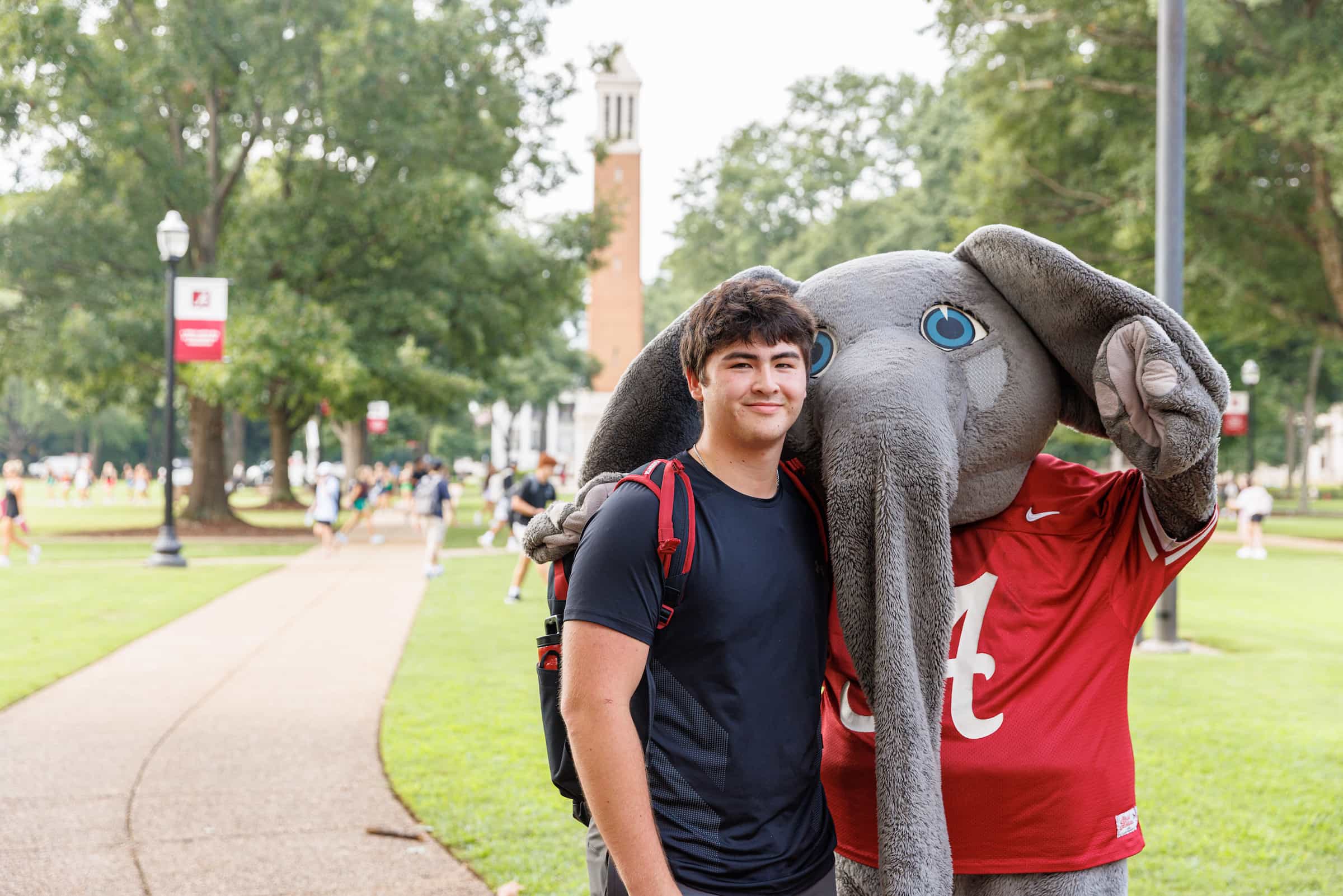 Student posing with Big Al in front of Denny Chimes