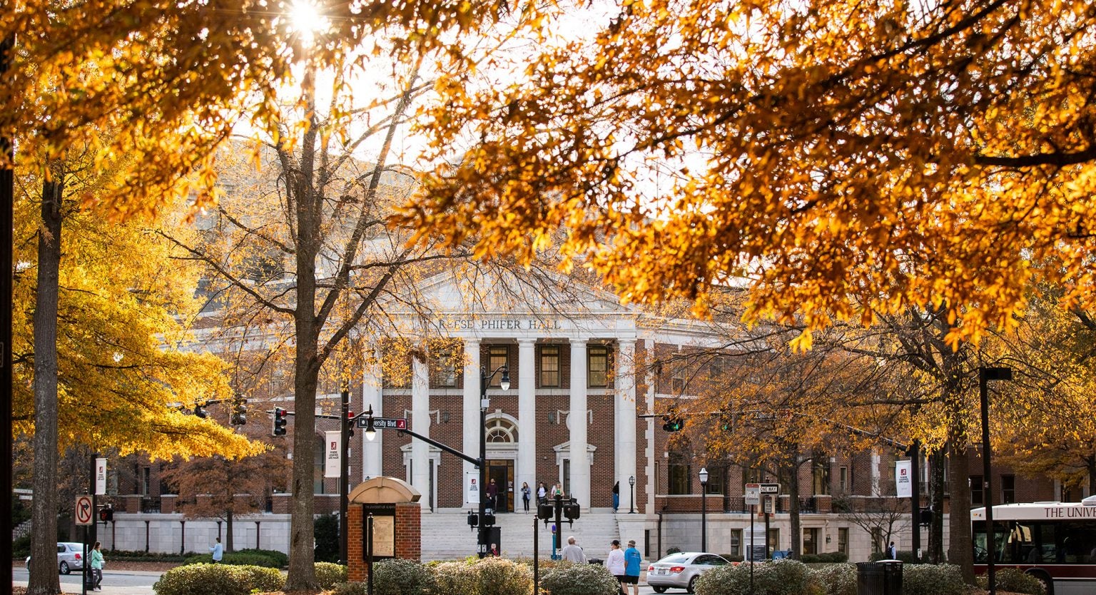 View of Reese Phifer Hall through golden Fall leaves on trees