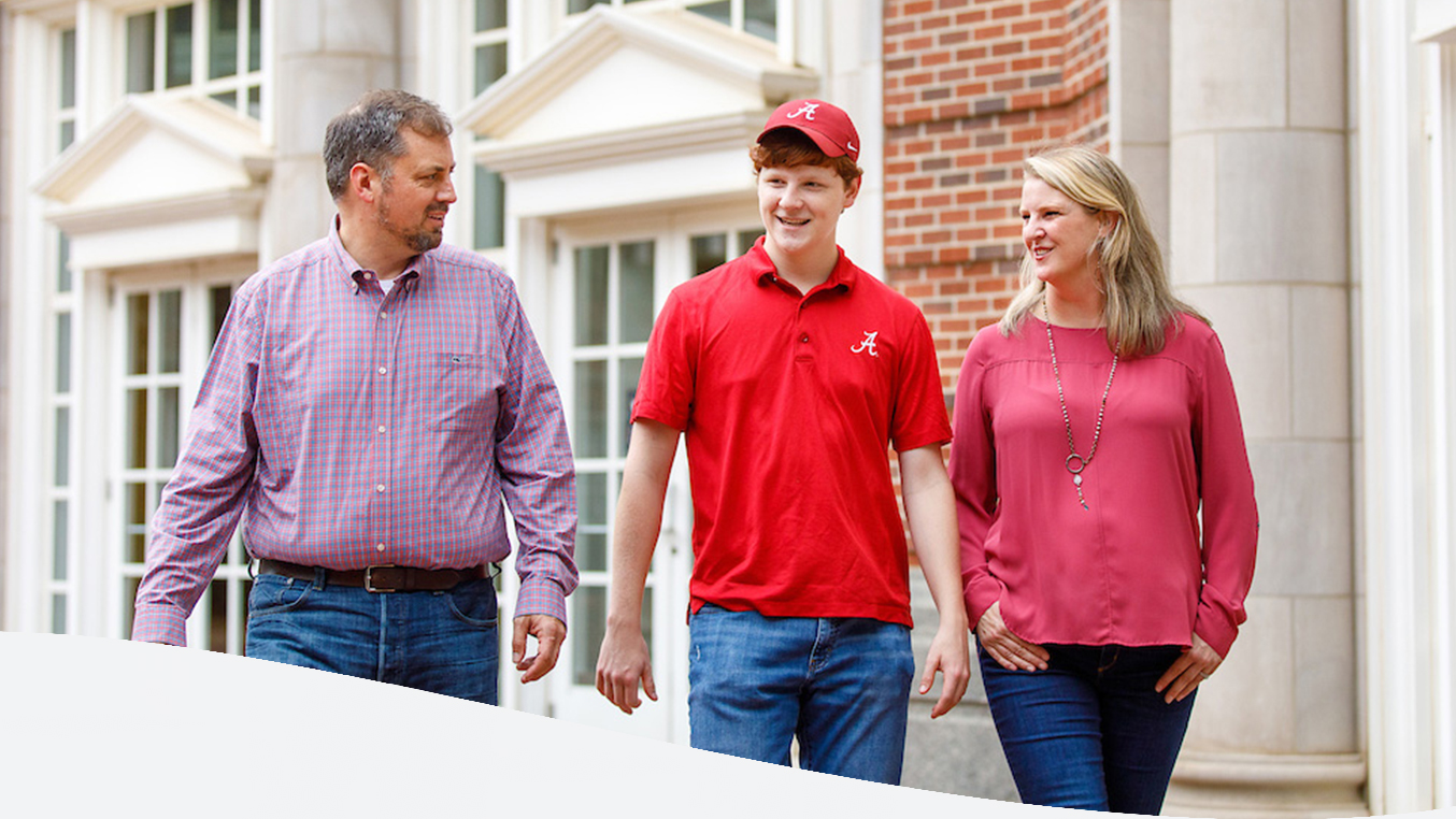 Student walking with his parents outside Shelby Hall
